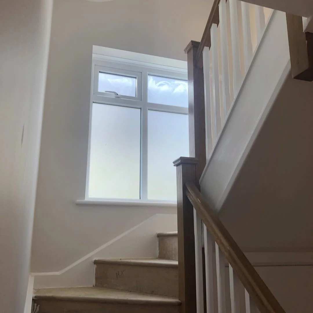 White painted staircase with oak handrail