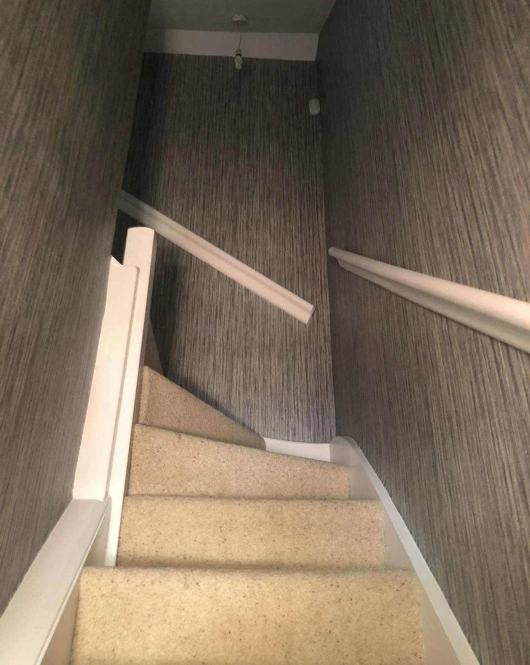 Grey textured stairwell wallpaper